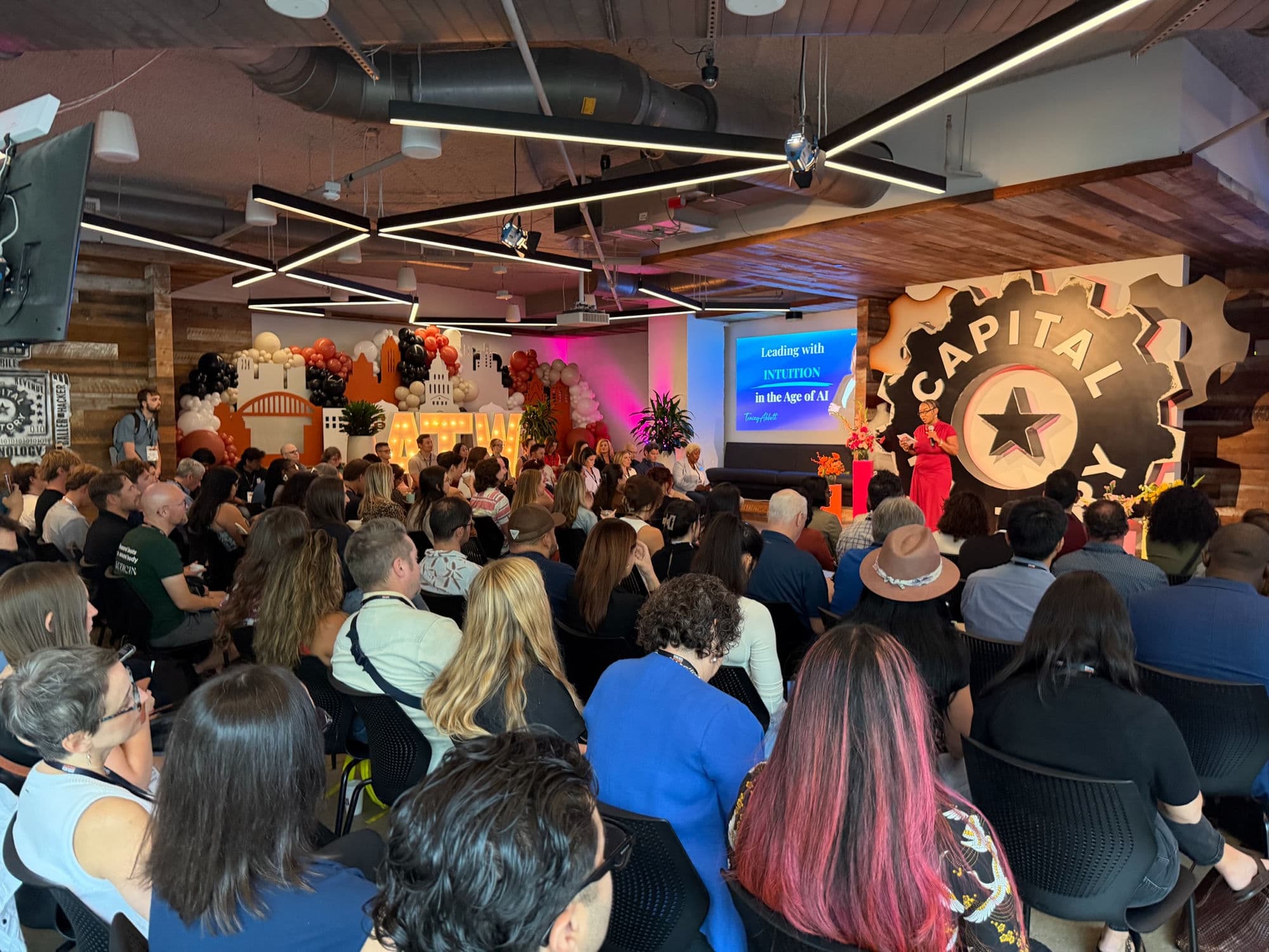 A packed demo-day session under the gear logo